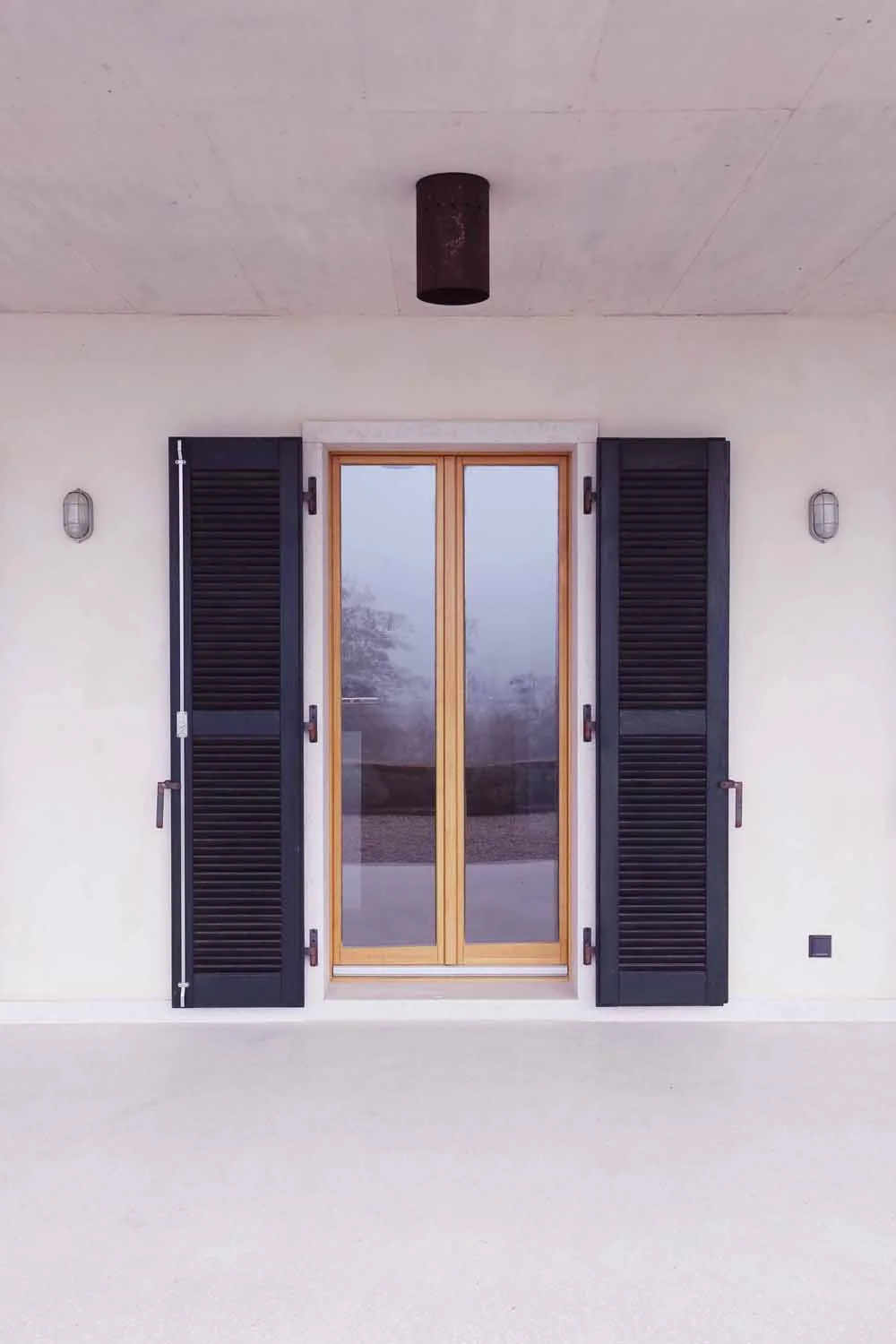 Hand-forged raw steel hinge on stone wall