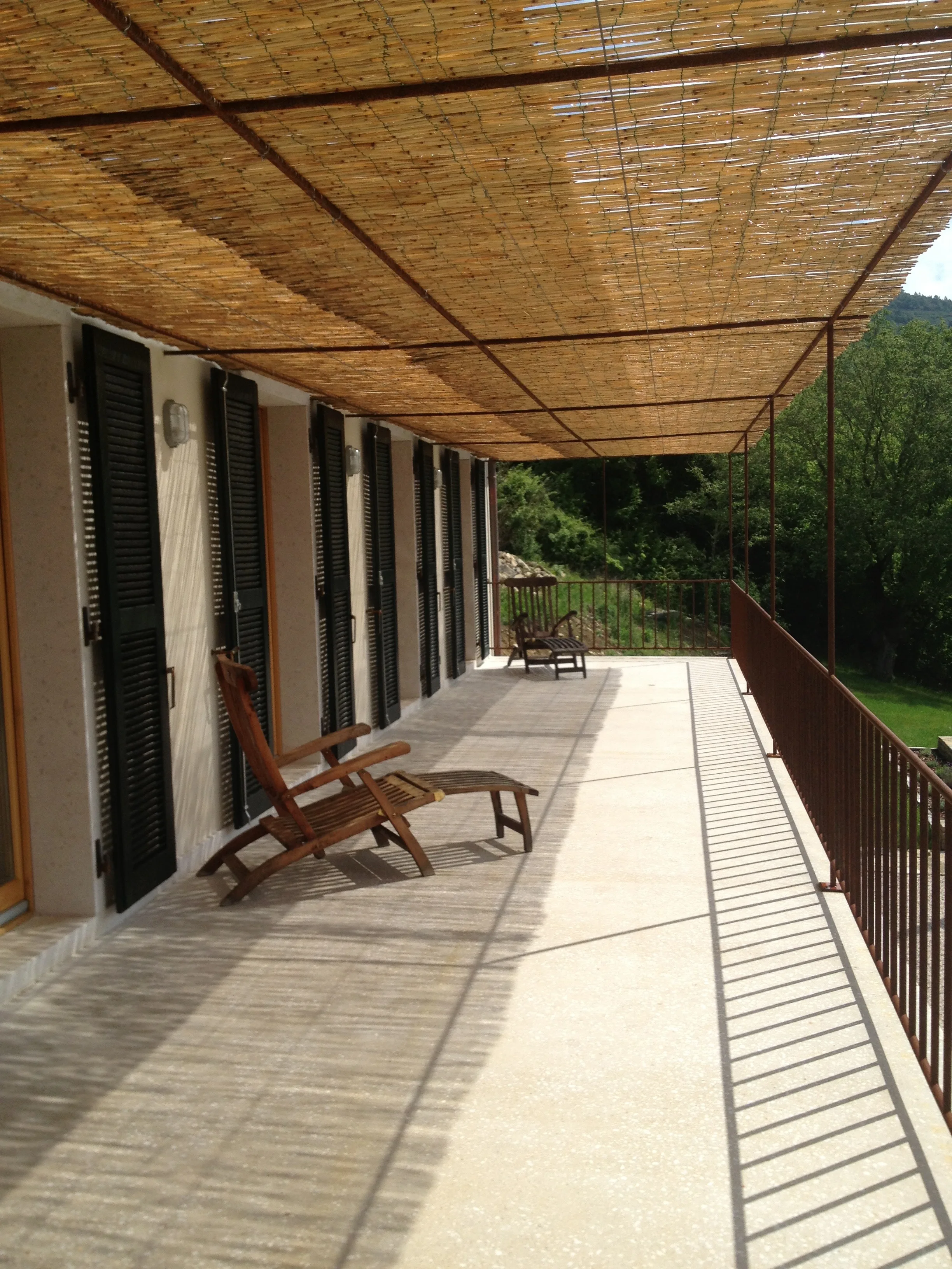 Upper terrace with bamboo sunshade and deck chairs