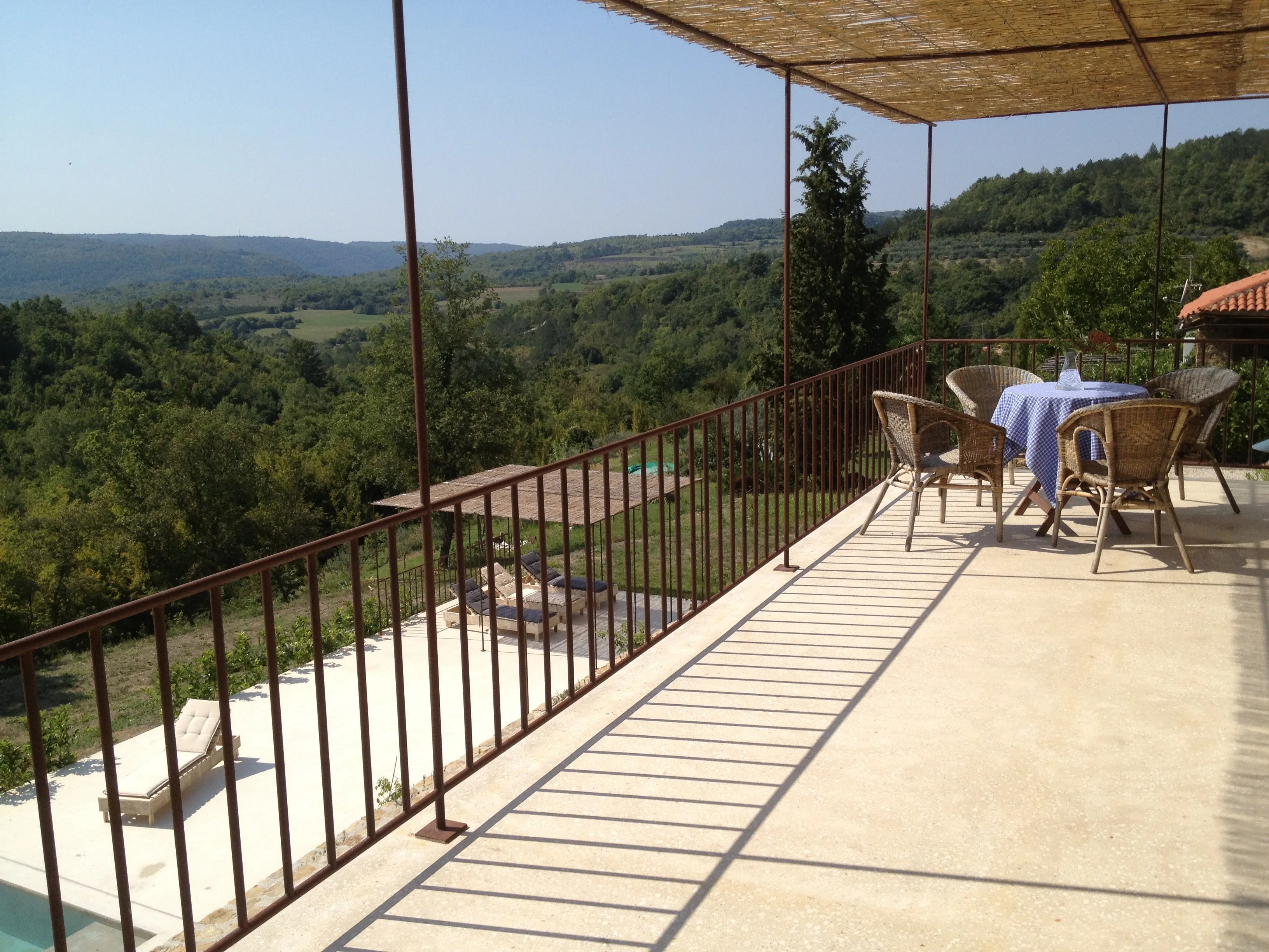 Upper terrace with four chairs and sweeping valley panorama